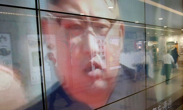 Passersby are reflected in a TV screen reporting news about North Korea's leader Kim Jong Un and their missile launch, in Tokyo, Japan, September 15, 2017. REUTERS/Issei Kato
