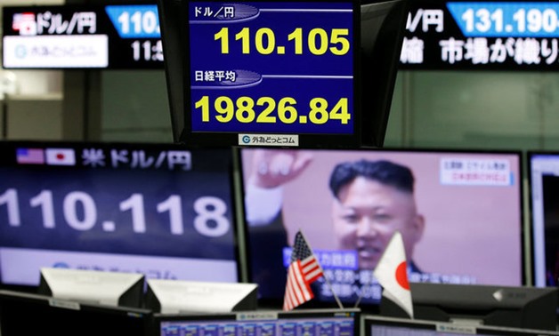 Monitors showing TV news on North Korea's missile launch, the Japanese yen's exchange rate against the U.S. dollar and Japan's Niikei share average are seen at a foreign exchange trading company in Tokyo - REUTERS