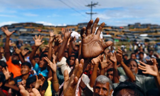 Rohingya refugees stretch their hands to receive aid distributed by local organisations at Balukhali makeshift refugee camp in Cox's Bazar, Bangladesh, September 14, 2017. REUTERS/Danish Siddiqui