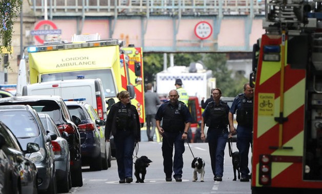 Police officers walk with dogs after an incident at Parsons Green underground station in London - REUTERS