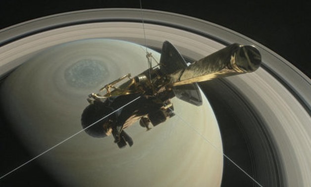 The spacecraft Cassini is pictured above Saturn's northern hemisphere prior to making one of its Grand Finale dives in this NASA handout illustration - REUTERS