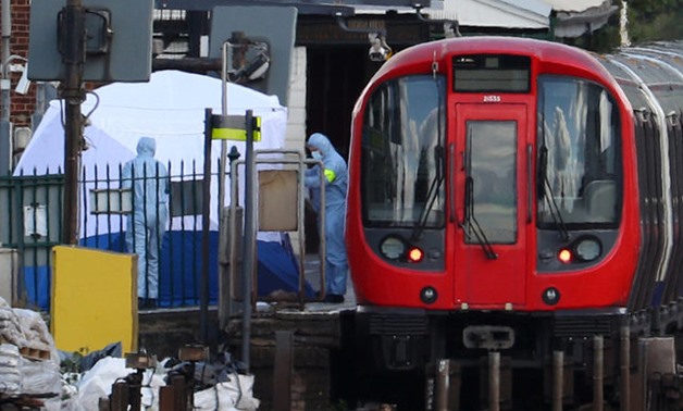 Forensic investigators search on the platform at Parsons Green tube station in London - REUTERS