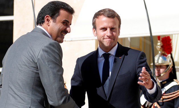 French President Emmanuel Macron (R) greets Qatar Emir Sheikh Tamim bin Hamad al-Thani at the Elysee Place in Paris, France, September 15, 2017. REUTERS/Charles Platiau
