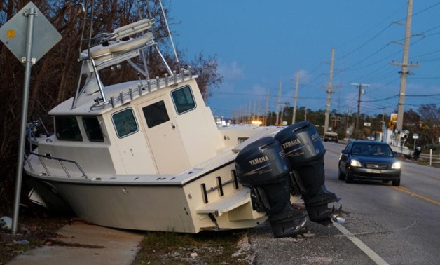 A boat lays across US 1 after Hurricane Irma in Big Pine Key, Florida, U.S., September 14, 2017 – REUTERS/Carlo Allegri