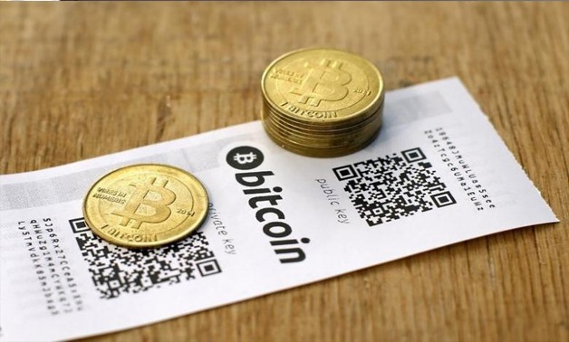 A Bitcoin (virtual currency) paper wallet with QR codes and coins are seen in an illustration picture taken at La Maison du Bitcoin in Paris July 11, 2014 - REUTERS/Benoit Tessier