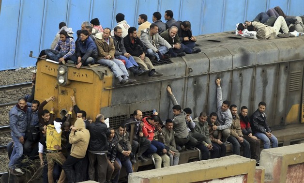 People travel on an overcrowded train in Cairo, Egypt in 2013 - Reuters