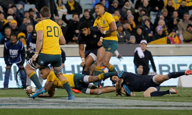 Rugby Union - Championship - Australia Wallabies vs Argentina Pumas - Canberra, Australia - September 16, 2017. Australia's Will Genia scores a try as Argentina's Nicolas Sanchez attempts a tackle. REUTERS/Jason Reed