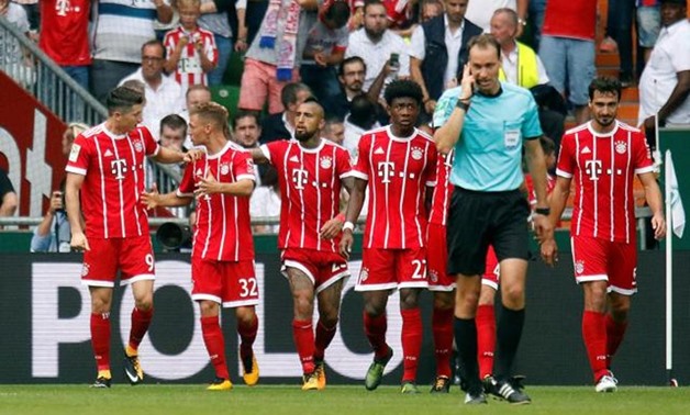 Bayern Munich's Robert Lewandowski celebrates scoring their first goal with Joshua Kimmich and team mates