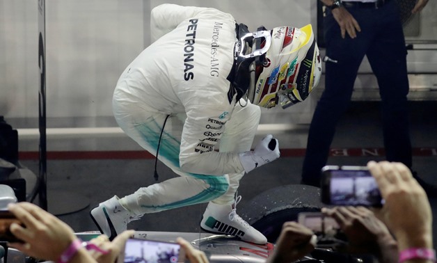 Lewis Hamilton celebrates after winning Singapore Grand Prix– Press image courtesy Reuters