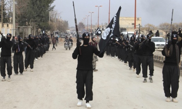 Islamic State militants parade in Tel Abyad, near Syria's border with Turkey. (Yaser Al-Khodor/Reuters)