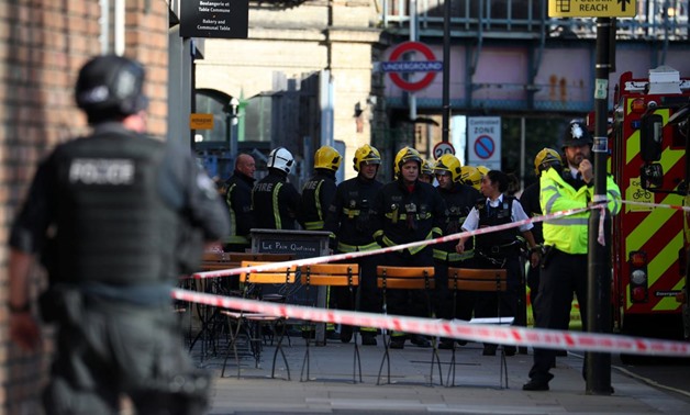 Members of the London Fire Brigade stand by cordon near Parsons Green tube station in London, Britain September 15, 2017 - REUTERS