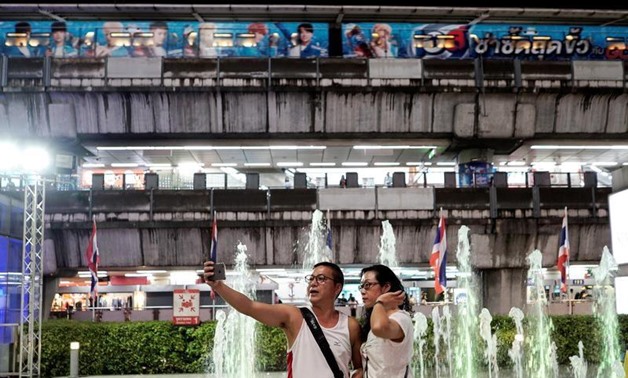 FILE PHOTO: Tourists take a selfie at a department store in Bangkok, Thailand, September 21, 2016. REUTERS/Athit Perawongmetha