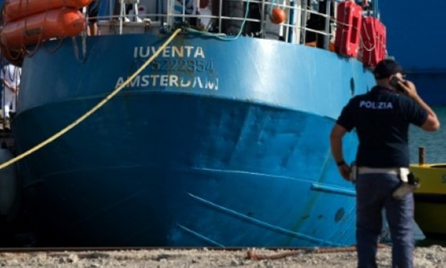 An Italian police officer stands by the Iuventa rescue ship run by German NGO Jugend Rettet (Youth Saves) arrives at the harbour of Trapani - AFP