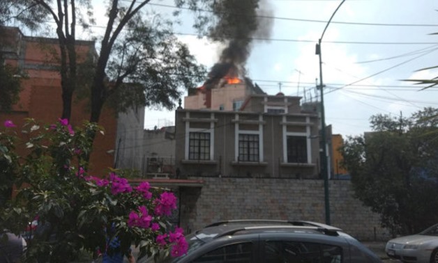 A building is seen on fire following an earthquake in Mexico city - REUTERS