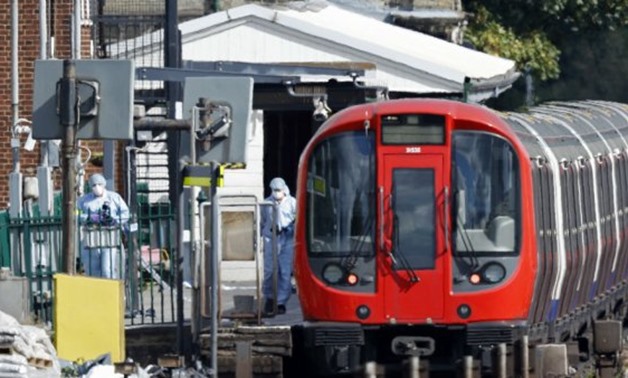 Police forensics officers works on a platform at Parsons Green Tube station in west London on September 15