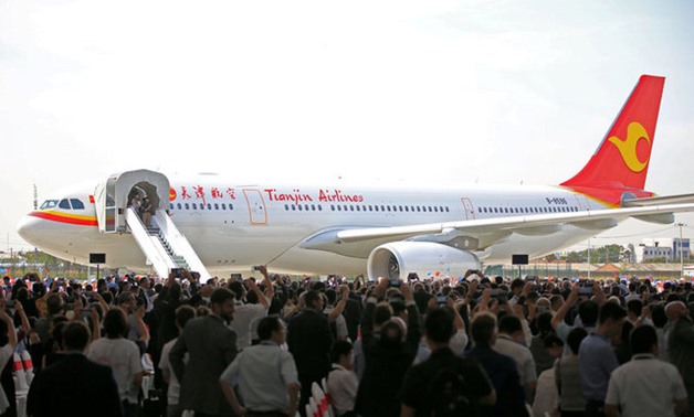 People look at the first Airbus A330 plane to be delivered from Airbus' Chinese completion plant for A330 jets to Tianjin Airlines, during the inauguration ceremony of the plant, in Tianjin, China September 20, 2017. REUTERS/Stringer ATTENTION EDITORS - T
