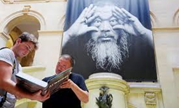 Chinese artist and free-speech advocate Ai Weiwei signs his book ahead of an exhibition titled "Ai Weiwei: By the way, it's always the others" at the Musee Cantonal des Beaux Arts in Lausanne, Switzerland September 20 2017. REUTERS/Pierre Albouy