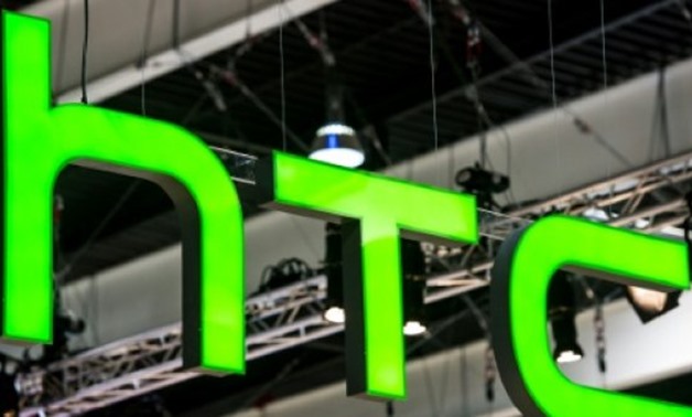 © AFP/File | A report says Google is close to buying a stake in Taiwan-based smartphone maker HTC, whose logo is displayed at the 2017 Mobile World Congress
