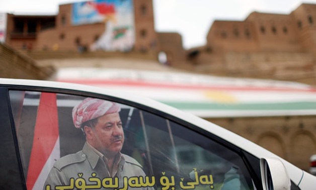 The picture of Iraqi Kurdish President Masoud Barzani is seen at the car window in the old city of Erbil, Iraq September 20, 2017. REUTERS/Ahmed Jadallah