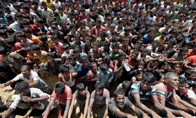 Rohingya refugees react as aid is distributed in Cox's Bazar, Bangladesh, September 21, 2017. REUTERS/Cathal McNaughton TPX IMAGES OF THE DAY