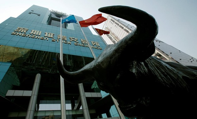 FILE PHOTO: A statue of a bull is displayed outside the Shenzhen Stock Exchange in the southern Chinese city of Shenzhen October 23, 2009. REUTERS/Bobby Yip/File Photo