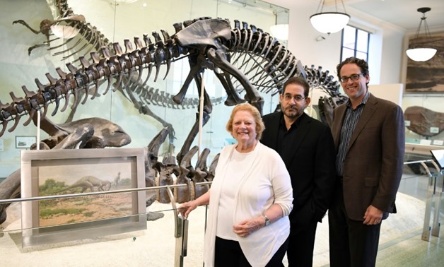 From L to R: Rhoda Knight Kalt, composer John Musto and librettist Eric Einhorn pose at the Dinosaur Hall of the American Museum of Natural History -AFP