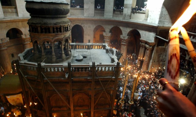 (Photo: Reuters)Christian-Orthodox worshippers perform the Holy Fire ceremony on April 26, 2003 inside the Church of the Holy Sepulchre