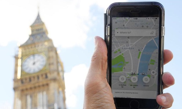 A photo illustration shows the Uber app on a mobile telephone, as it is held up for a posed photograph in central London, Britain September 22, 2017. REUTERS/Toby Melville