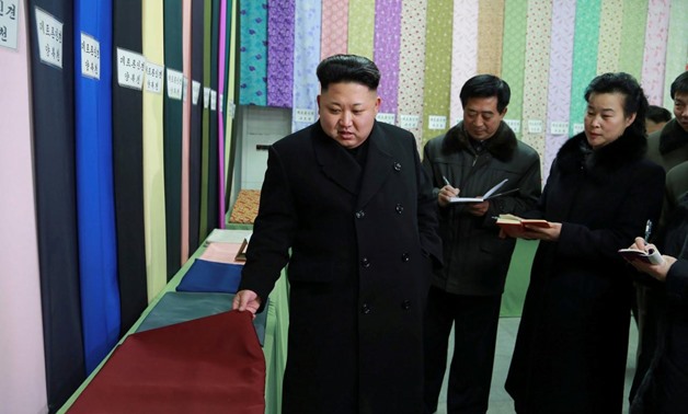 FILE PHOTO North Korean leader Kim Jong Un (L) gives field guidance at the Kim Jong Suk Pyongyang Textile Mill in this undated photo released by North Korea's Korean Central News Agency (KCNA) in Pyongyang December 20, 2014. KCNA via REUTERS/File Photo