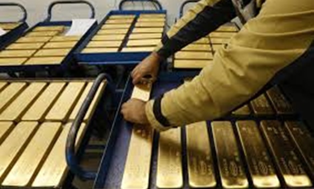 An employee places ingots of 99.99 percent pure gold on a cart at the Krastsvetmet non-ferrous metals plant, one of the world's largest producers in the precious metals industry, in the Siberian city of Krasnoyarsk, Russia September 22, 2017. REUTERS/Ilya