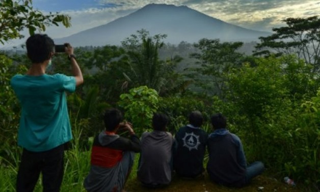 People look at Mount Agung in Karangasem on the Indonesian resort island of Bali on September 24, 2017