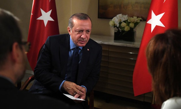 Turkish President Tayyip Erdogan (C) speaks during an interview with Reuters Editor-in-Chief Steve Adler (L) and Reuters Chief Correspondent Parisa Hafezi (R) at The Peninsula hotel on the sidelines of the United Nations General Assembly in Manhattan, New