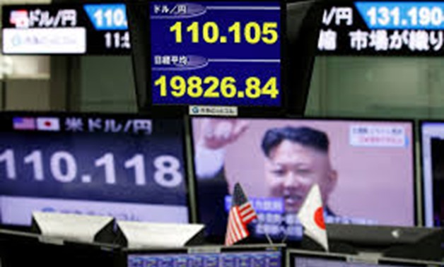 Monitors showing TV news on North Korea's missile launch (R), the Japanese yen's exchange rate against the U.S. dollar (L and top of blue screen) and Japan's Niikei share average (bottom of blue screen) are seen at a foreign exchange trading company in To