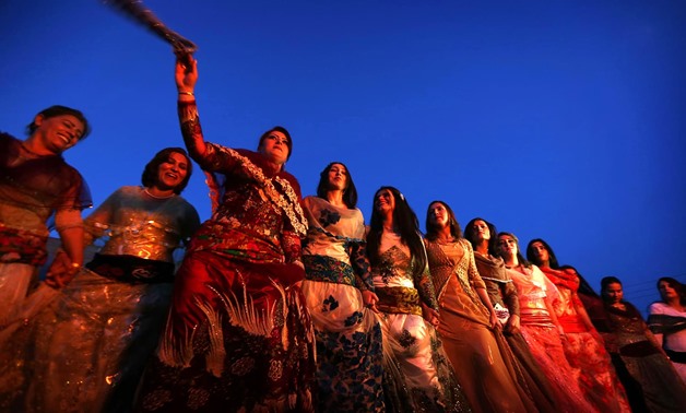 Iranian Kurdish women perform a traditional dance as they celebrate Nowruz.- AFP
