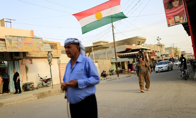 Kurdish people walk in the street of Kurdish neighbourhood in Tuz Khurmato, Iraq September 24, 2017. REUTERS/Thaier Al-Sudani