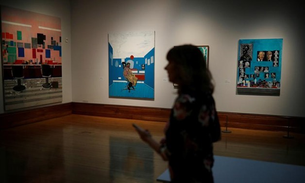 A woman walks past paintings by Turner Prize nominee Hurvin Anderson at the press preview for the 2017 Turner Prize at Ferens Art Gallery in Hull, Britain September 25, 2017. REUTERS/Phil Noble