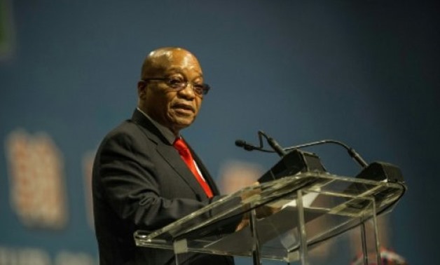 © AFP/File / by Susan NJANJI | South African president Jacob Zuma is accused of looting state resources and colluding with an influential business family
