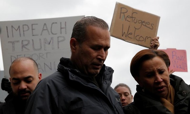 Iraqi immigrant Hameed Darwish (C) walks out of Terminal 4 with Congressman Jerrold Nadler (L) and Congresswoman Nydia Velazquez (R) after being released at John F. Kennedy International Airport in Queens, New York, U.S., January 28, 2017. REUTERS