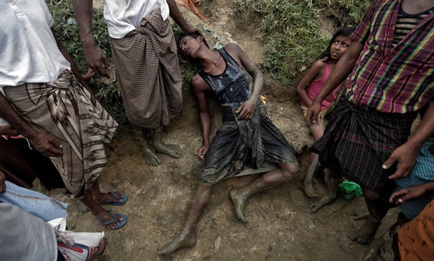 A Rohingya refugee collapses while waiting to receive aid in Cox's Bazar, Bangladesh - REUTERS