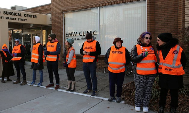 Escorts who ensure women can reach the clinic lineup as they face off protesters outside the EMW Women's Surgical Center in Louisville - REUTERS