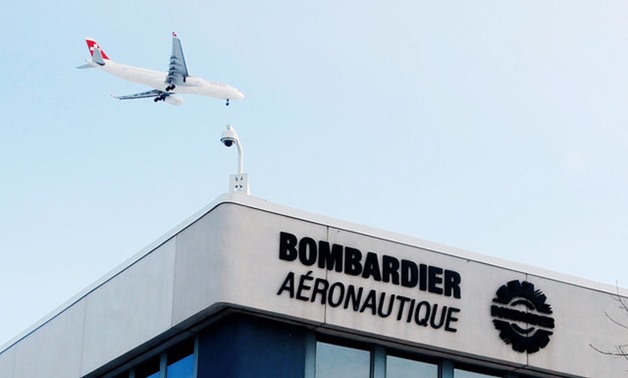 A plane flies over a Bombardier plant in Montreal - REUTERS