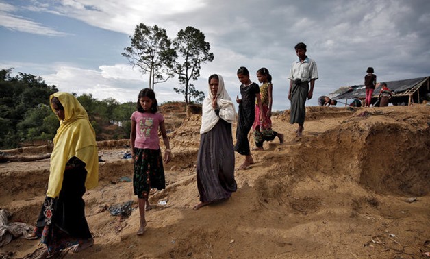 Rohingya refugees walk through a camp in Cox's Bazar, Bangladesh, September 27, 2017. REUTERS/Cathal McNaughton
