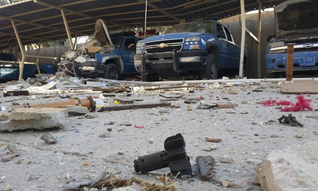 Police vehicles are parked next to debris in the Anbar province town of Hit - REUTERS