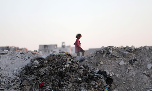 A child collects waste at the landfill near the Syrian city of Al-Bab, Syria, September 28, 2017. REUTERS/Khalil Ashawi