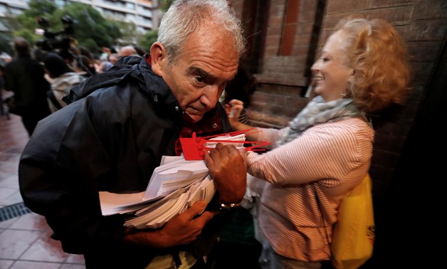 A man holds ballots at a polling station for the banned independence referendum in Barcelona, Spain October 1, 2017. REUTERS/Yves Herman