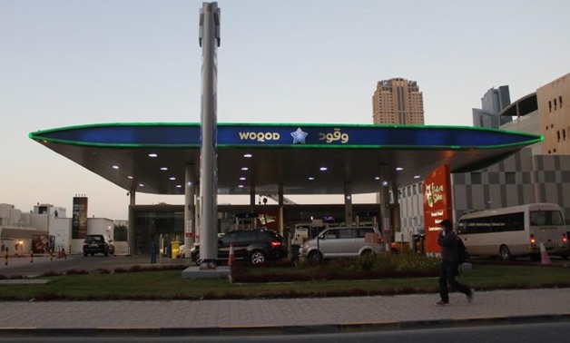 A man walks past Woqod oil station in Doha, Qatar January 28, 2016. REUTERS/Naseem Zeitoon