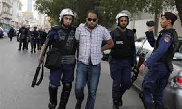 An anti-government protester is arrested by riot police during a protest in front of Ministry of Interior in Manama, April 27, 2012. REUTERS
