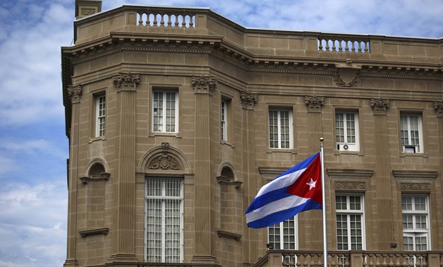 The Cuban national flag is seen raised over their new embassy in Washington July 20, 2015. REUTERS/Carlos Barria