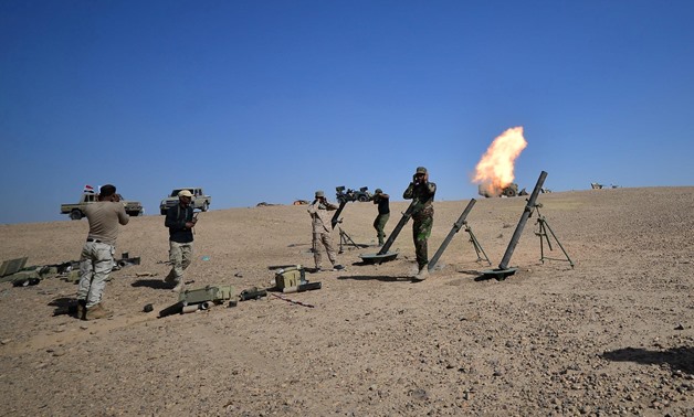 Shi'ite Popular Mobilization Forces (PMF) fire a mortar shell towards Islamic State militants' positions in Al-Al-Fateha military airport south of Hawija, Iraq, October 2, 2017. REUTERS