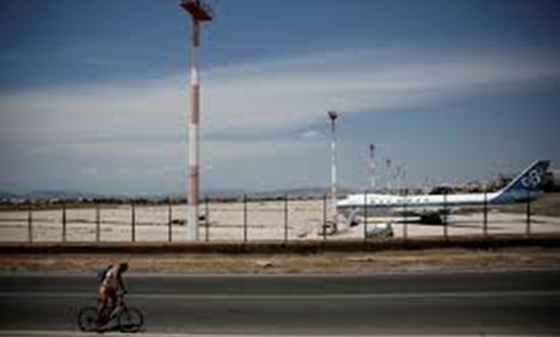A man rides his bike along the former international Hellenikon airport in Athens, Greece, July 16, 2017.Picture taken July 16, 2017. REUTERS/Costas Baltas - REUTERS